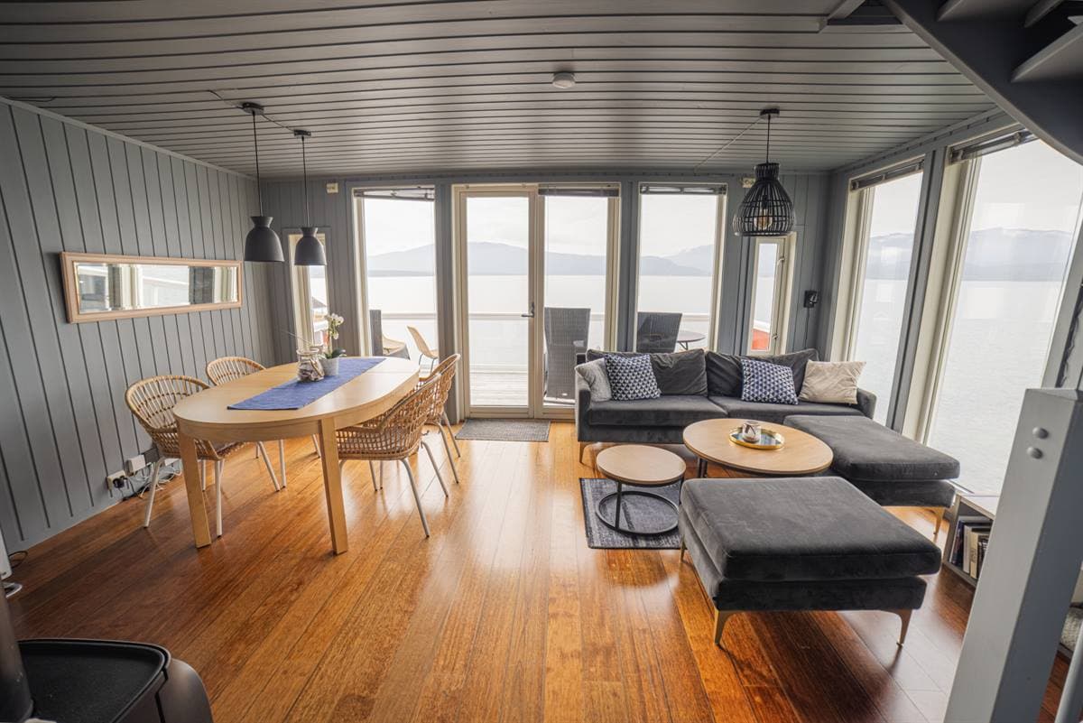 Living room with dining table and fjord view