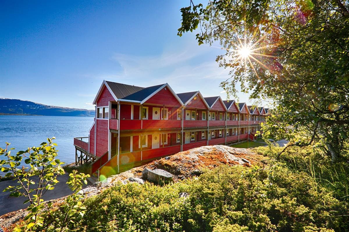 The red apartment building by the sea on a sunny summer day
