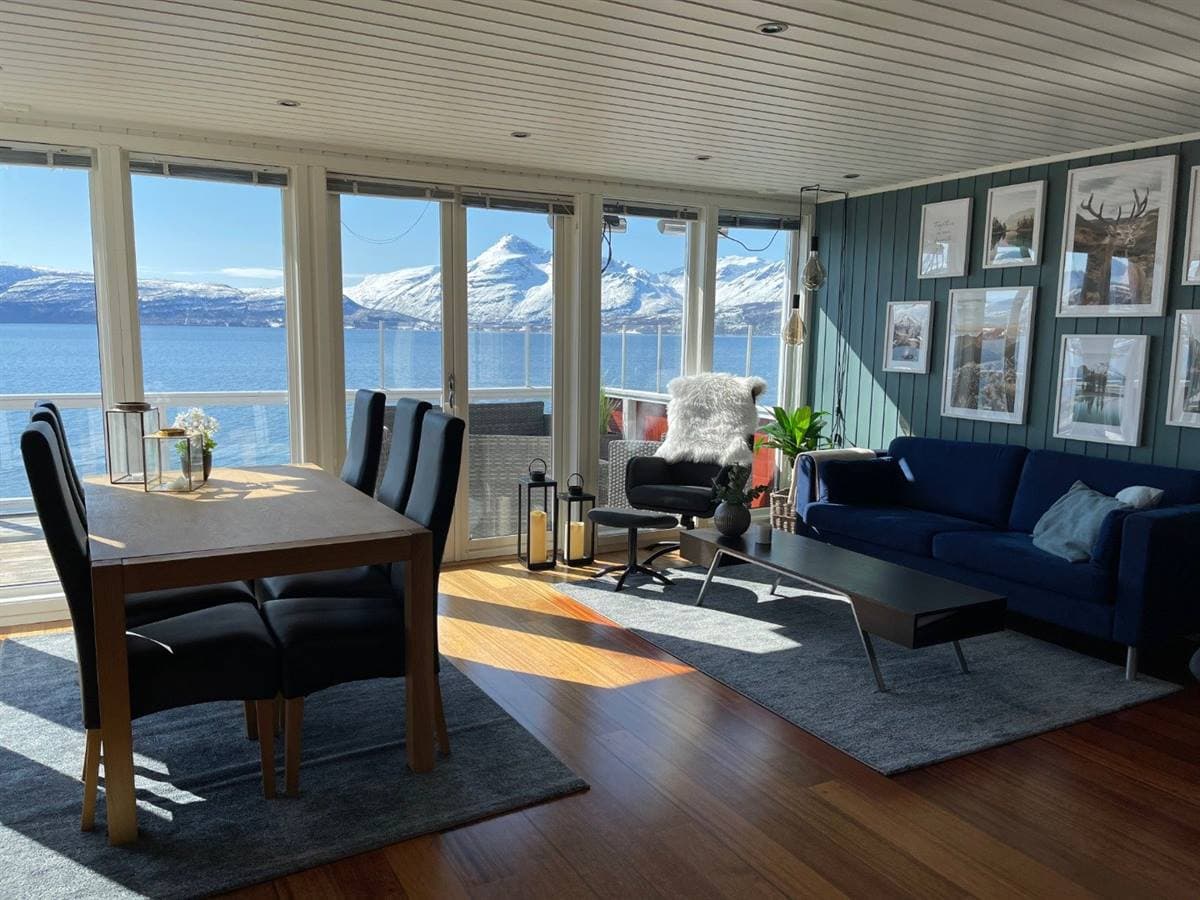 Living and dining area with views of the fjord and the mountains
