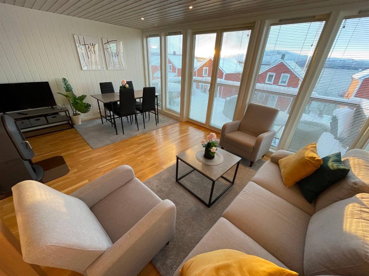 Living and dining area with panoramic windows over the winter landscape