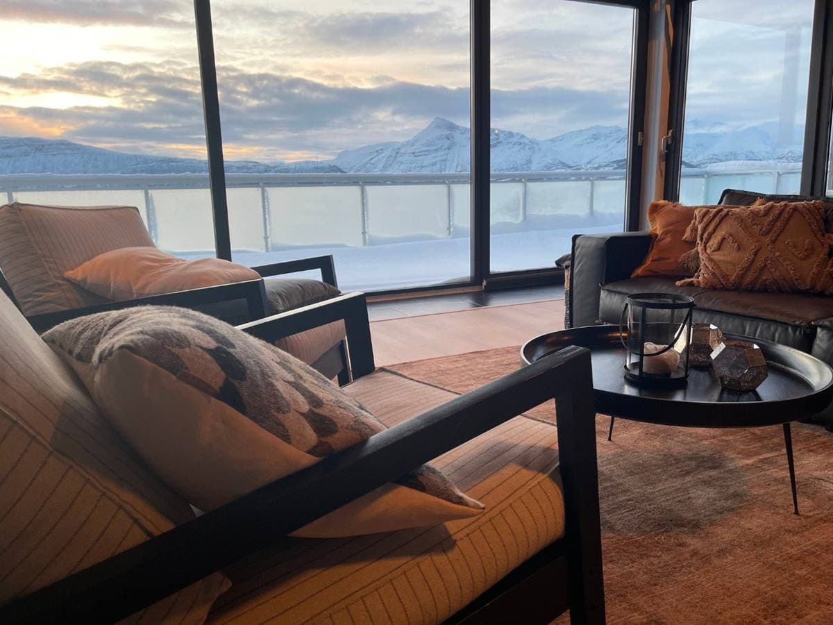 Lounge seating with a view over the snowy fjord