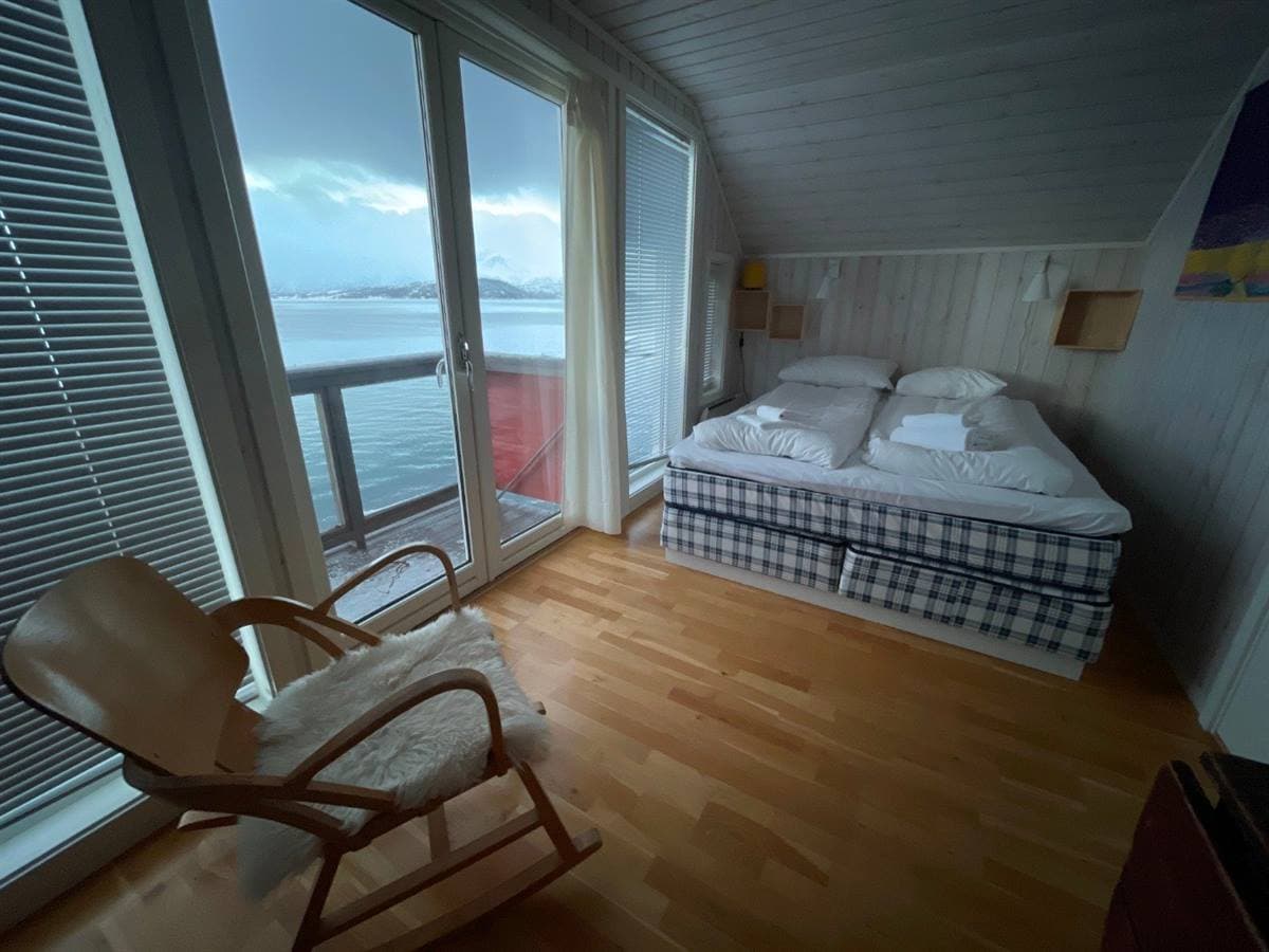 Double bedroom with a fjord-facing window and a rocking chair