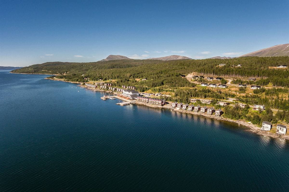 Aerial view of Malangen Resort along the shore of the Malangen fjord in summer