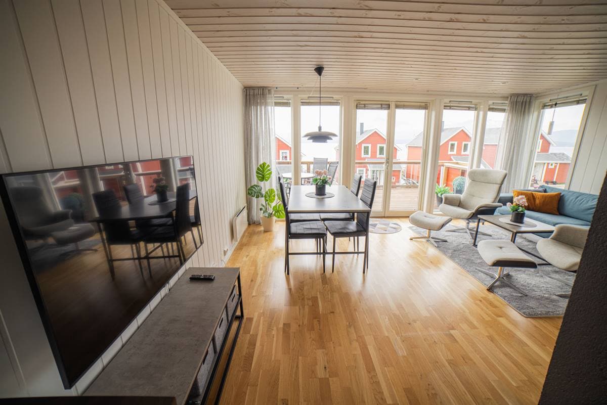 Open-plan living and dining area with large windows
